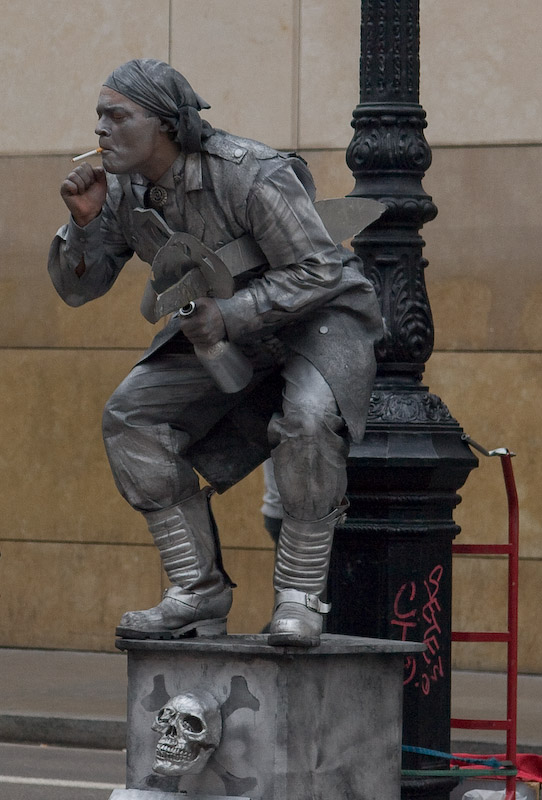 A human statue takes a puff